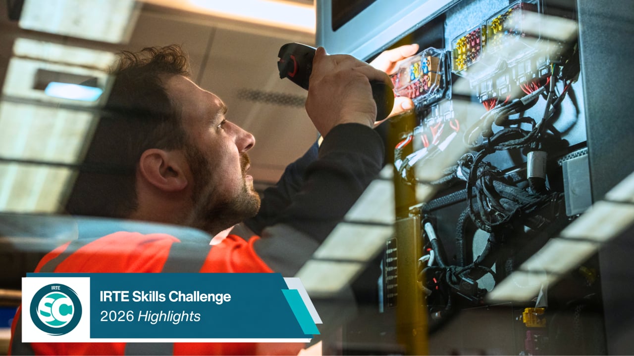 Worker in a safety vest wiring an electrical panel; banner reads 'IRTE Skills Challenge 2026 Highlights'