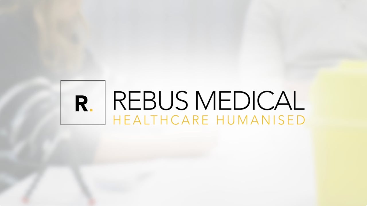 Rebus Medical logo with the tagline Healthcare Humanised on a pale blurred background.